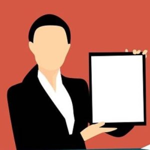 faceless person wearing a suit holding a blank whiteboard up.